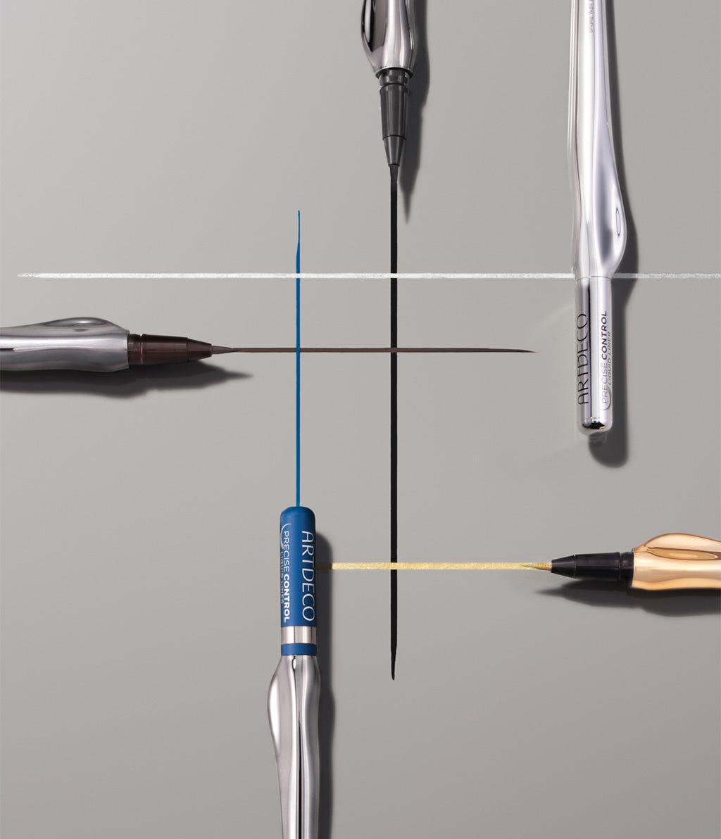 Precise Control Liquid Liner liegen auf einem grauen Hintergrund. Die einzelnen Farben werden beim jeweiligen Linier in einem Linien Muster dargestellt.