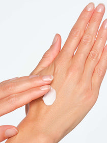 Close-up auf eine Hand auf welche eine Handcreme aufgetragen wird